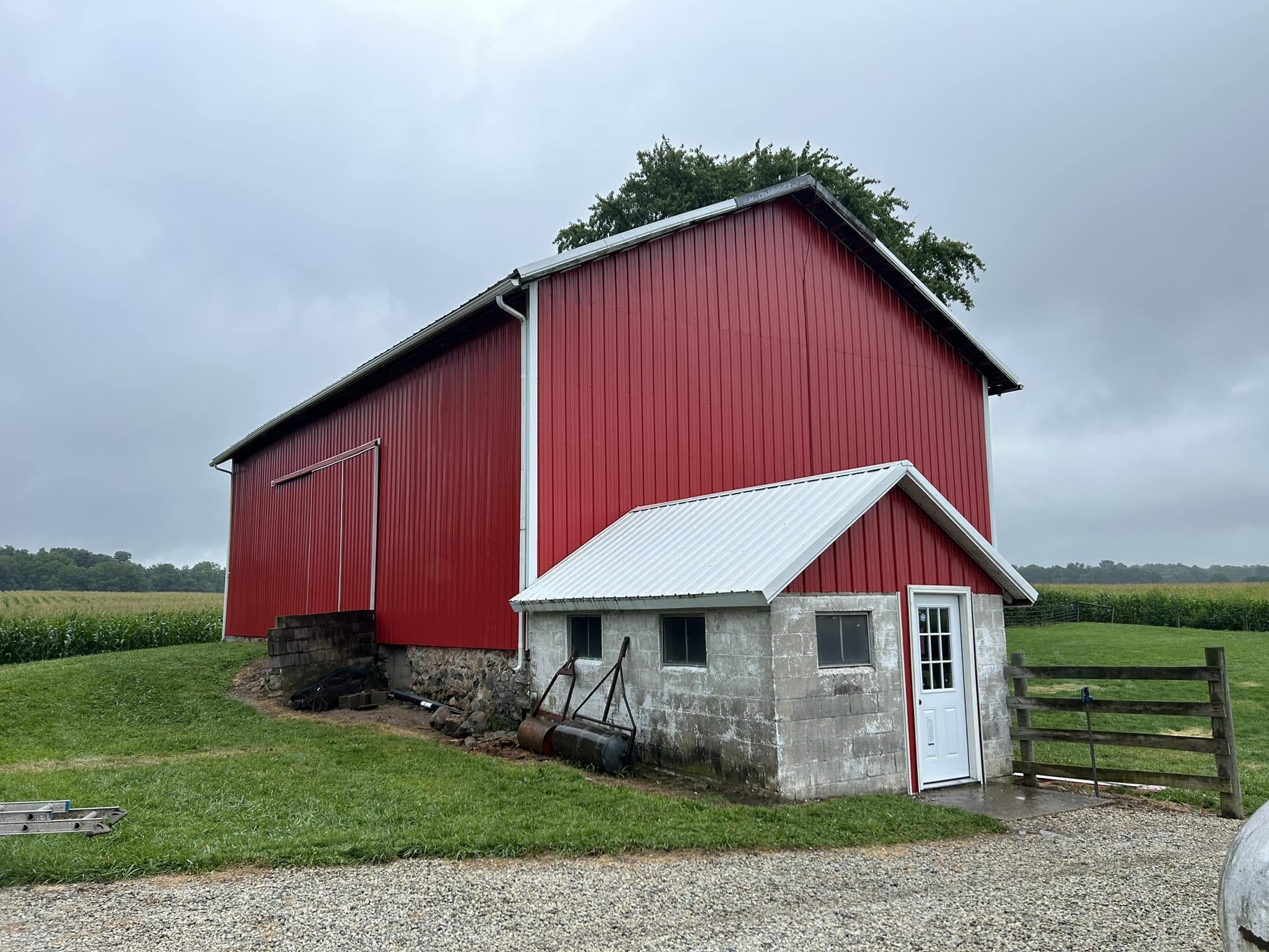 Red barn roofing and siding restoration by Stidham's