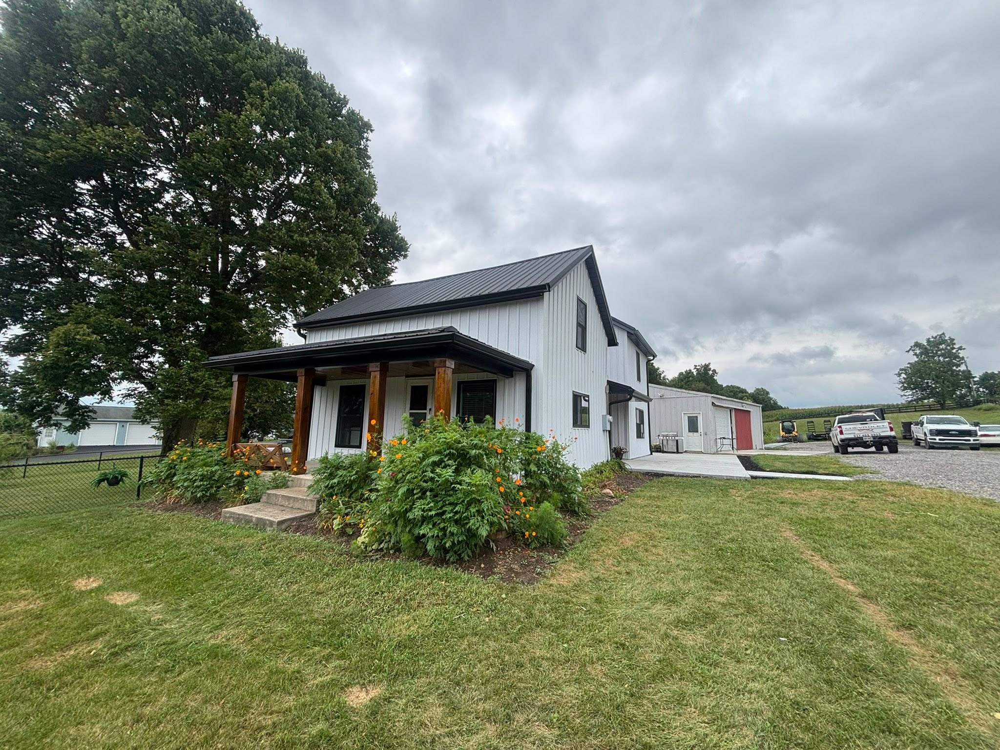 Farmhouse with new standing-seam metal roof by Stidham's Painting & Roofing
