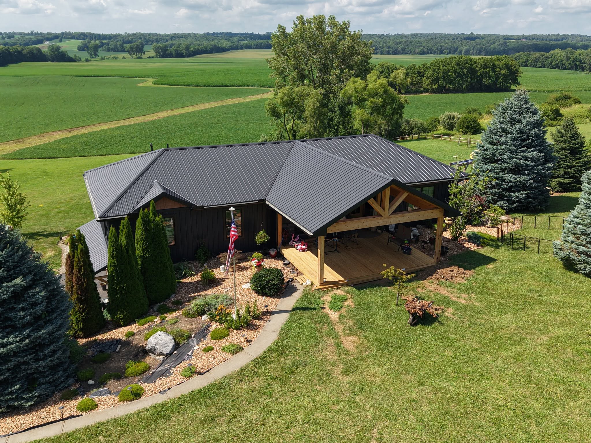 Black standing-seam metal roof installed by Stidham's